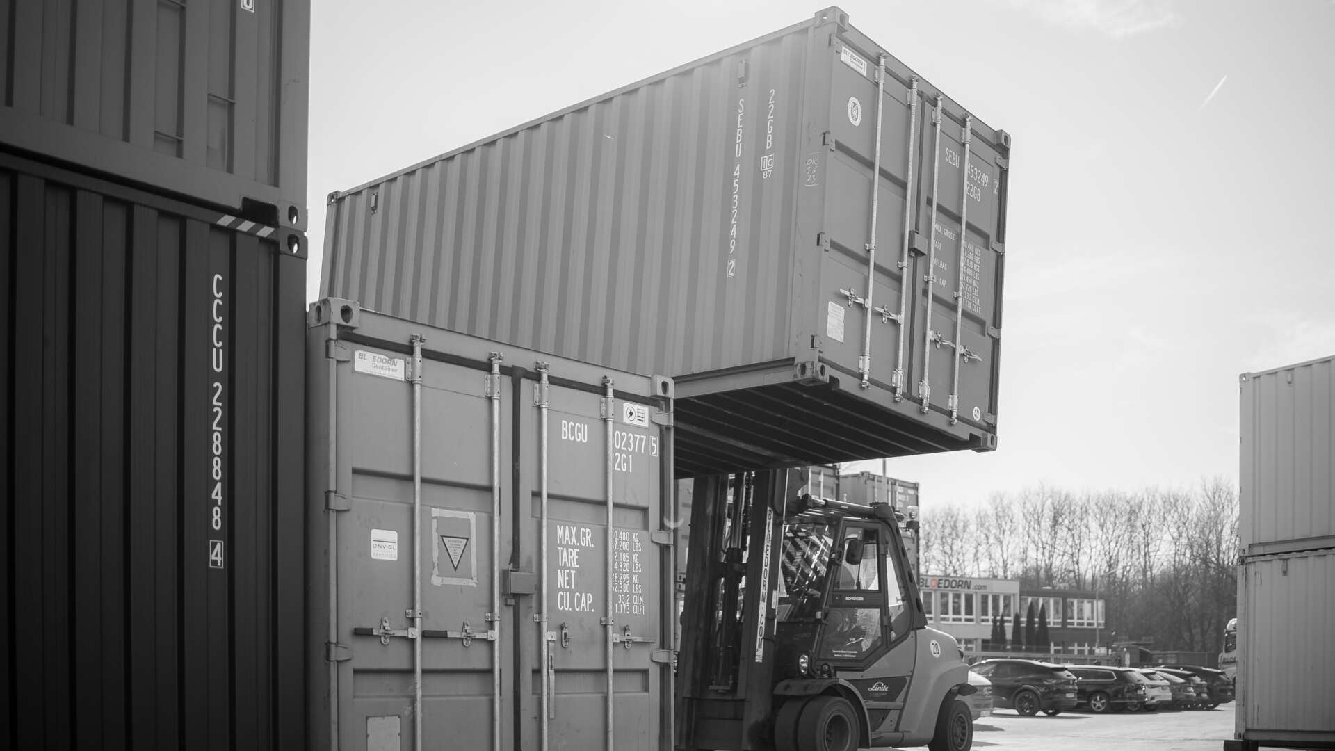 Gabelstapler hebt einen Container auf einen anderen